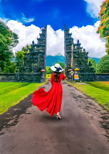 woman-walking-big-entrance-gate-bali-indonesia